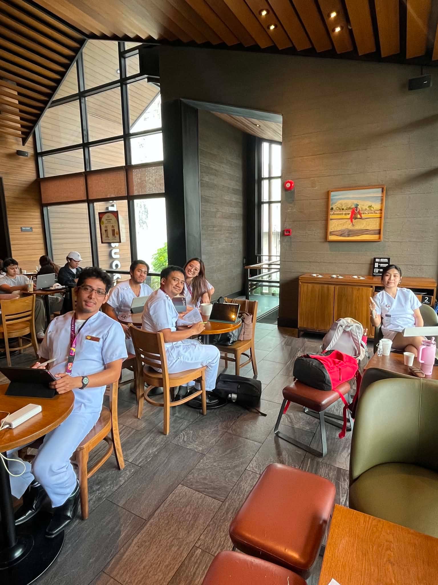 Franz and classmates in medical uniforms gathered at a café